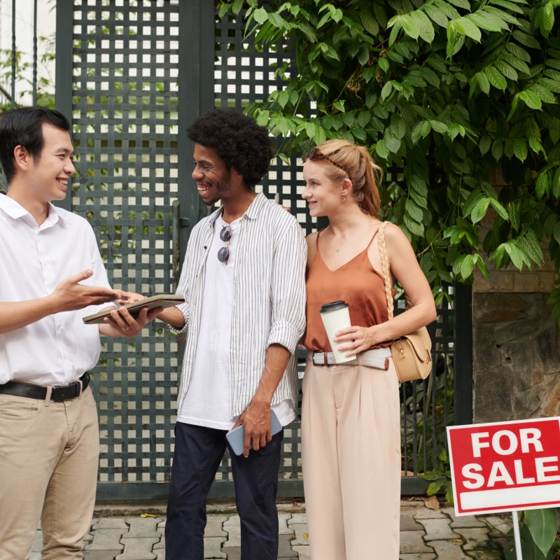 Positive real estate agent talking to clients discussing their preferences and expectations